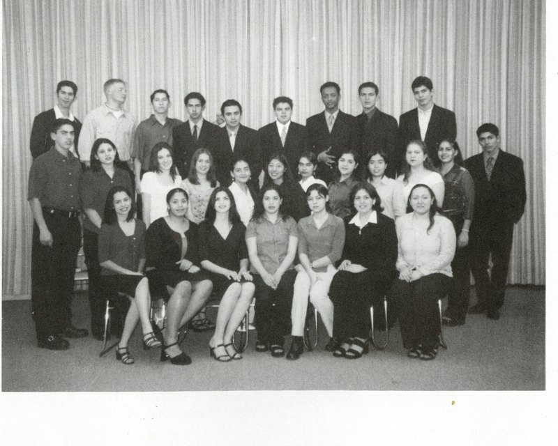 'Class of 2000' group photo in the auditorium.