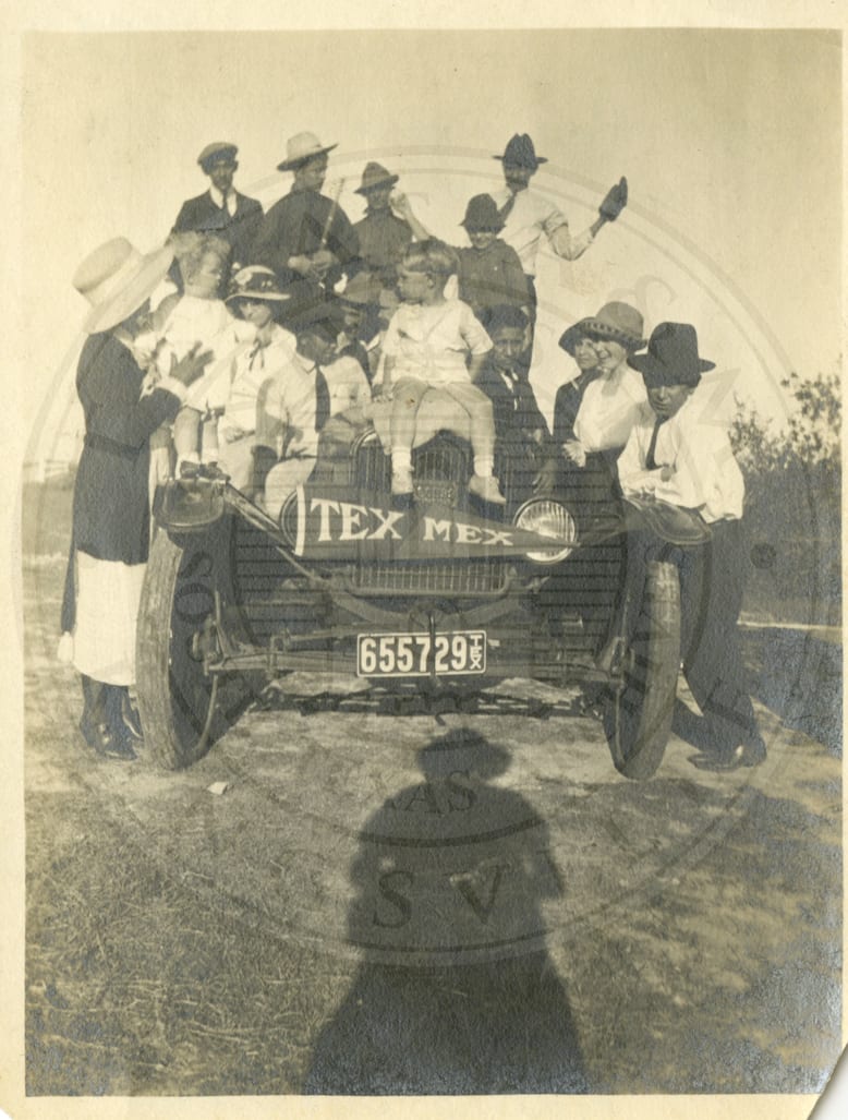 The school truck, a Tex-Mex flag on its nose, and everyone around it.