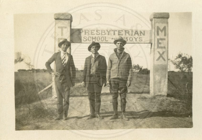 Three boys at the arch over the entrance to Tex-Mex.
