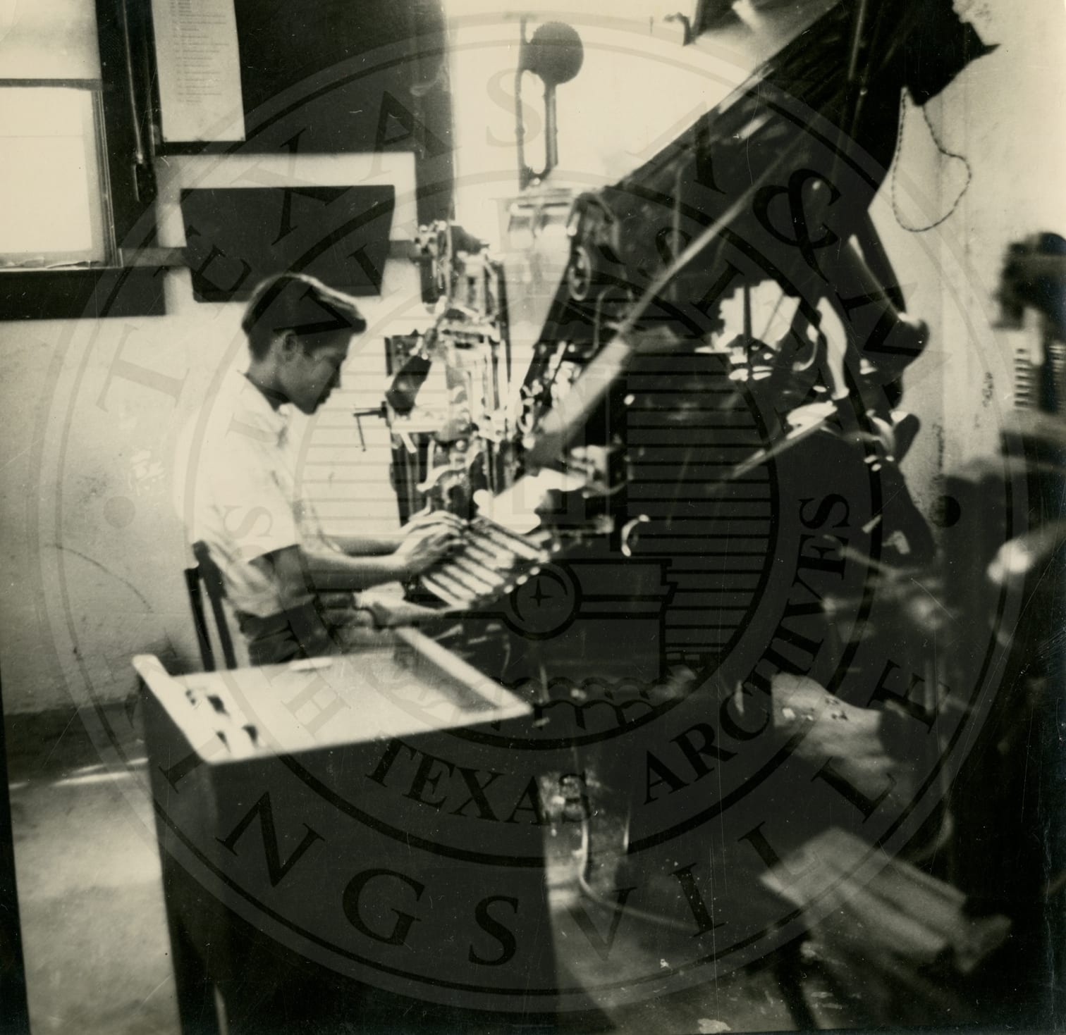 A student at the linotype in the print shop.