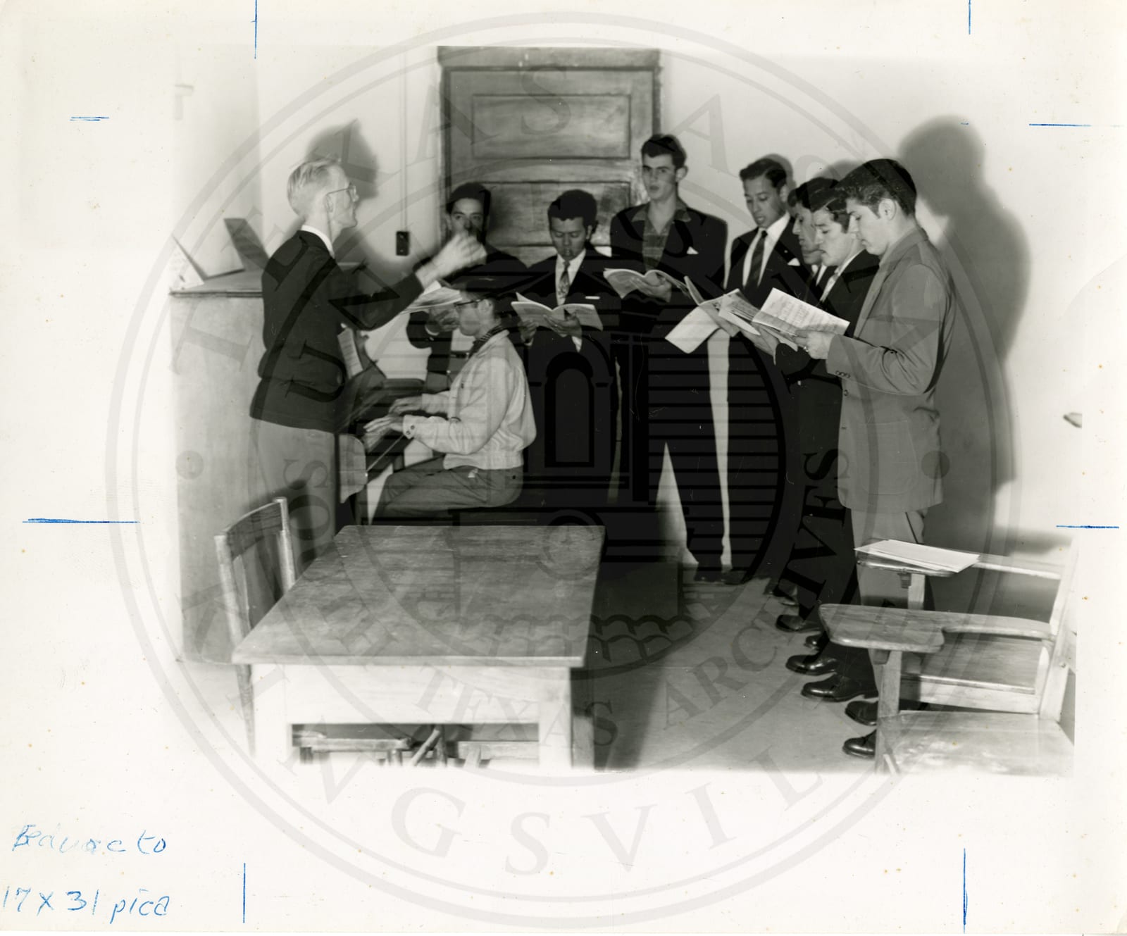Mr. Grier directing the octet in practice for Christmas music, Mr. Nease at the piano.