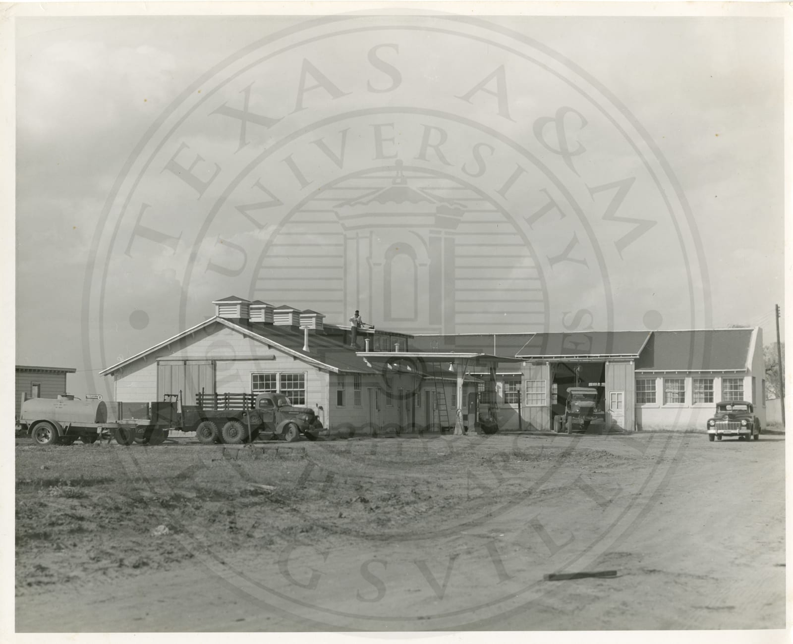 Students repairing the roof of the machine shop.