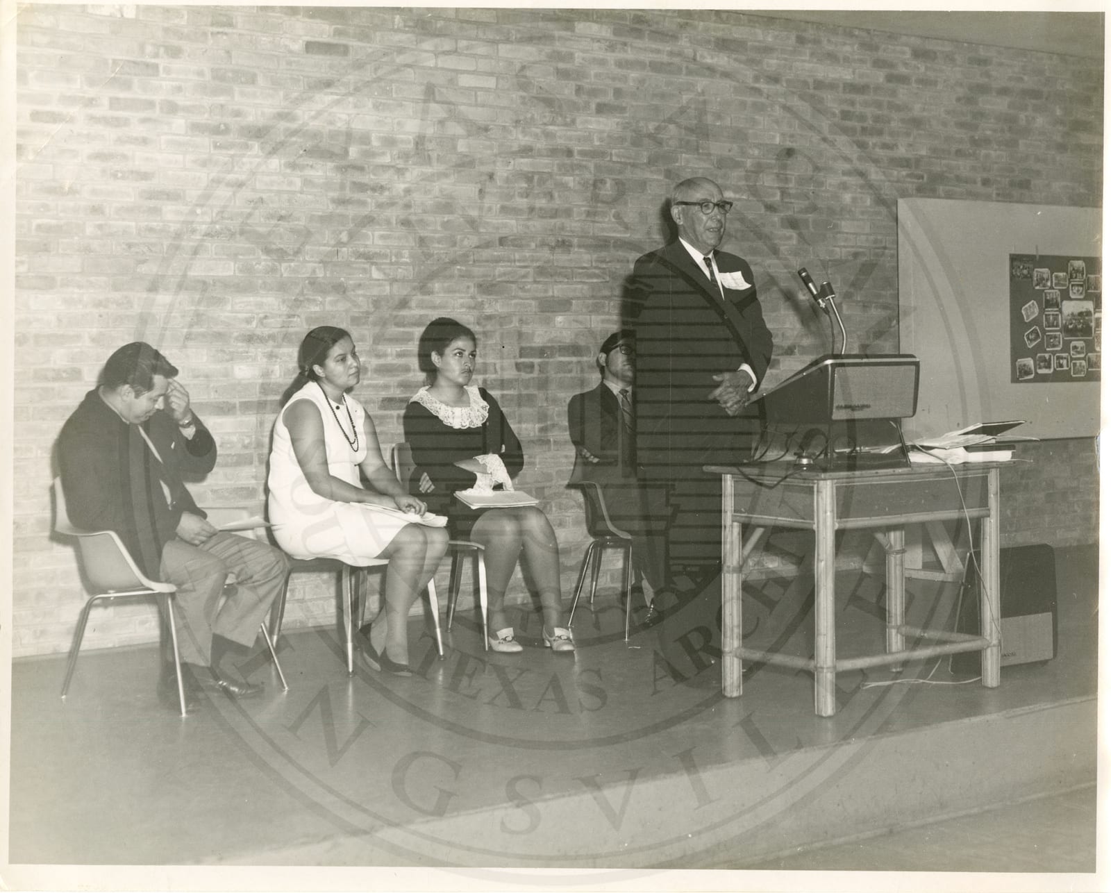 A speaker at the podium on stage.