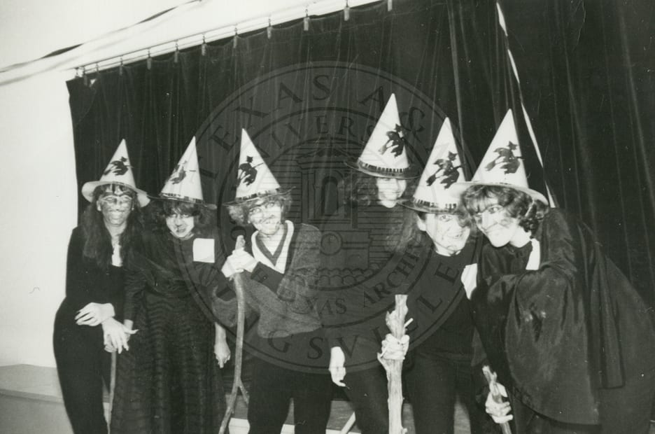 Dressed as witches.