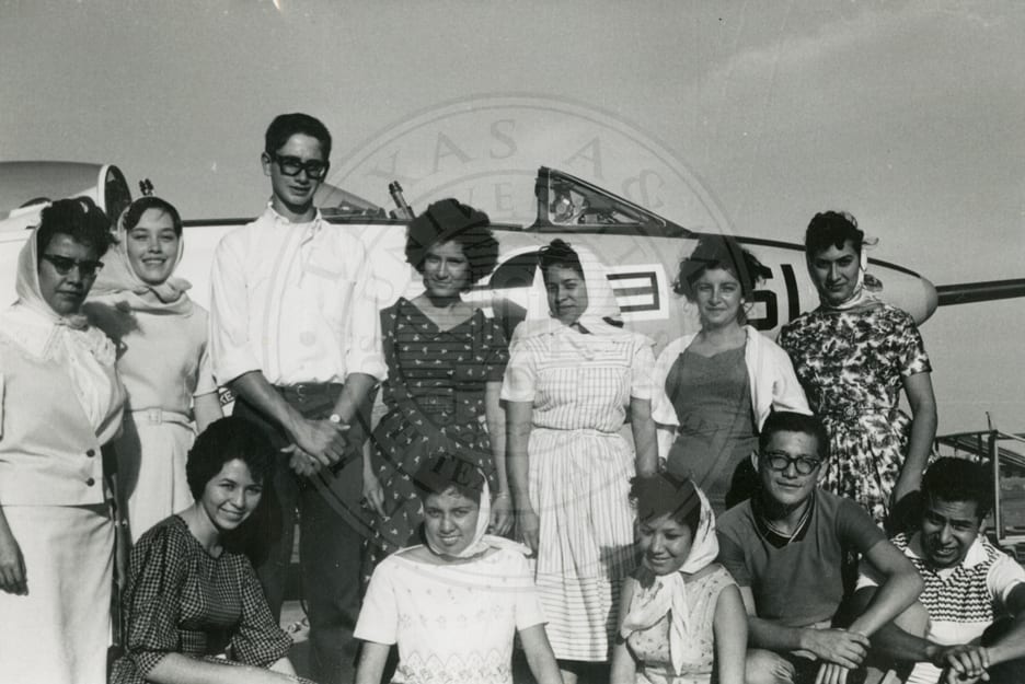 Students beside an aeroplane.