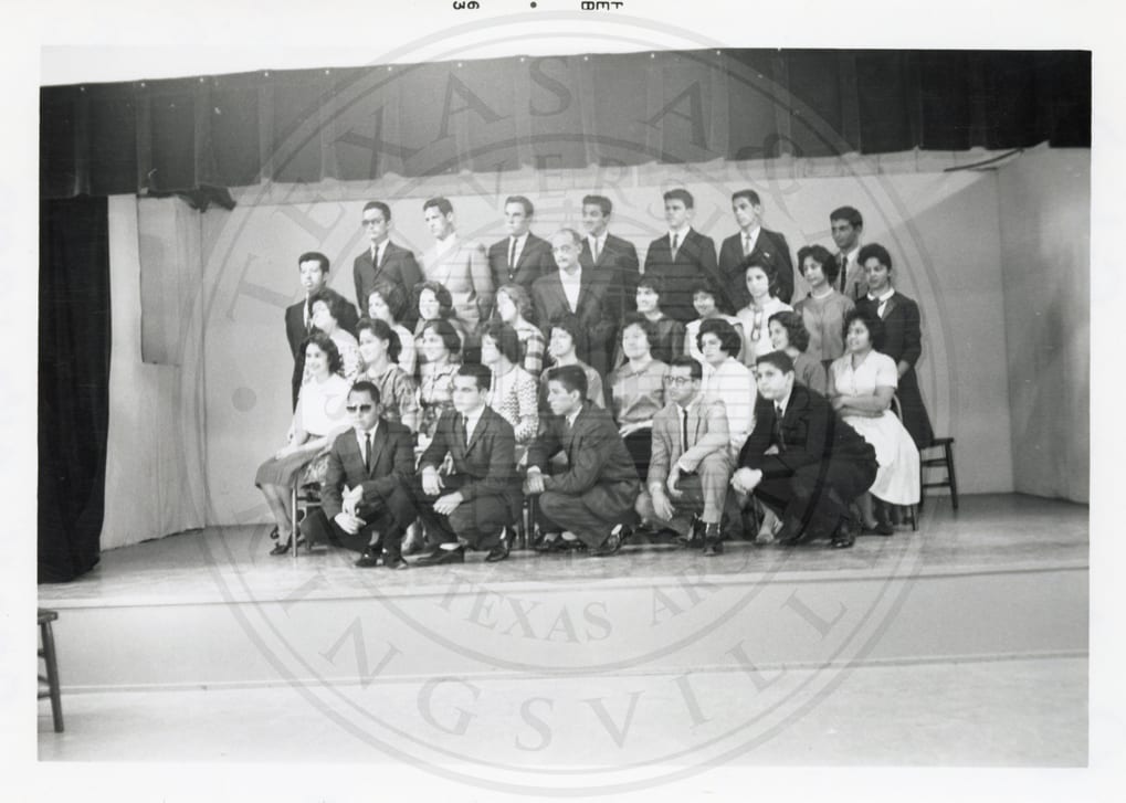 Students on stage with a teacher, February 1963.