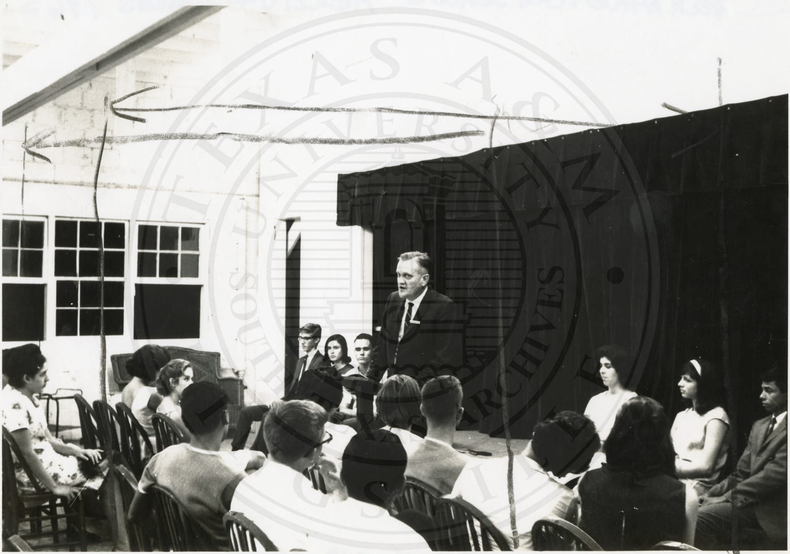 A faculty member at the lectern, 1965.