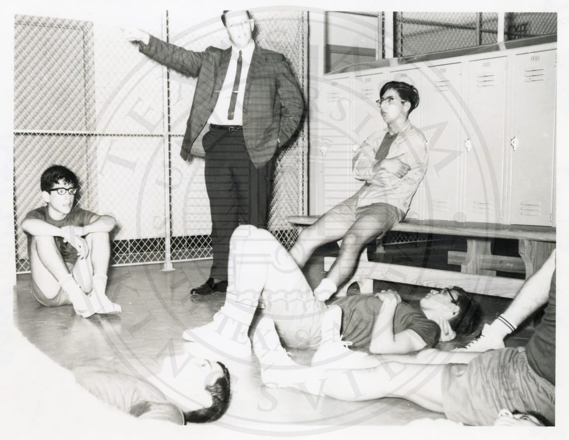 Coach and boys in the locker room, 1965–66.