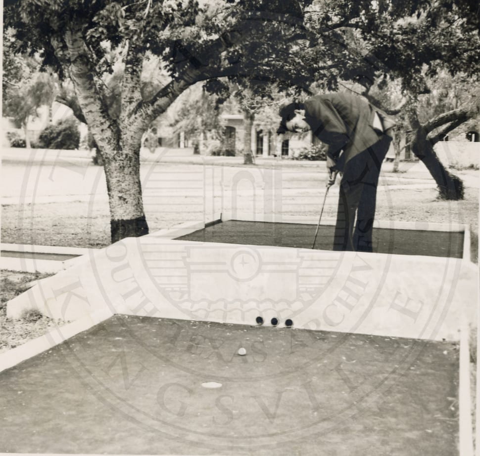 Mini golf: lining up a putt, 1972.