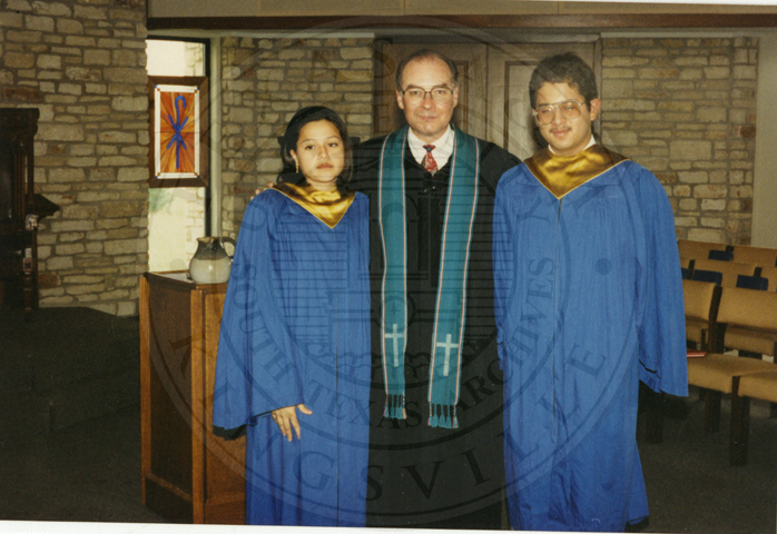 The pastor with choir members, 1994.