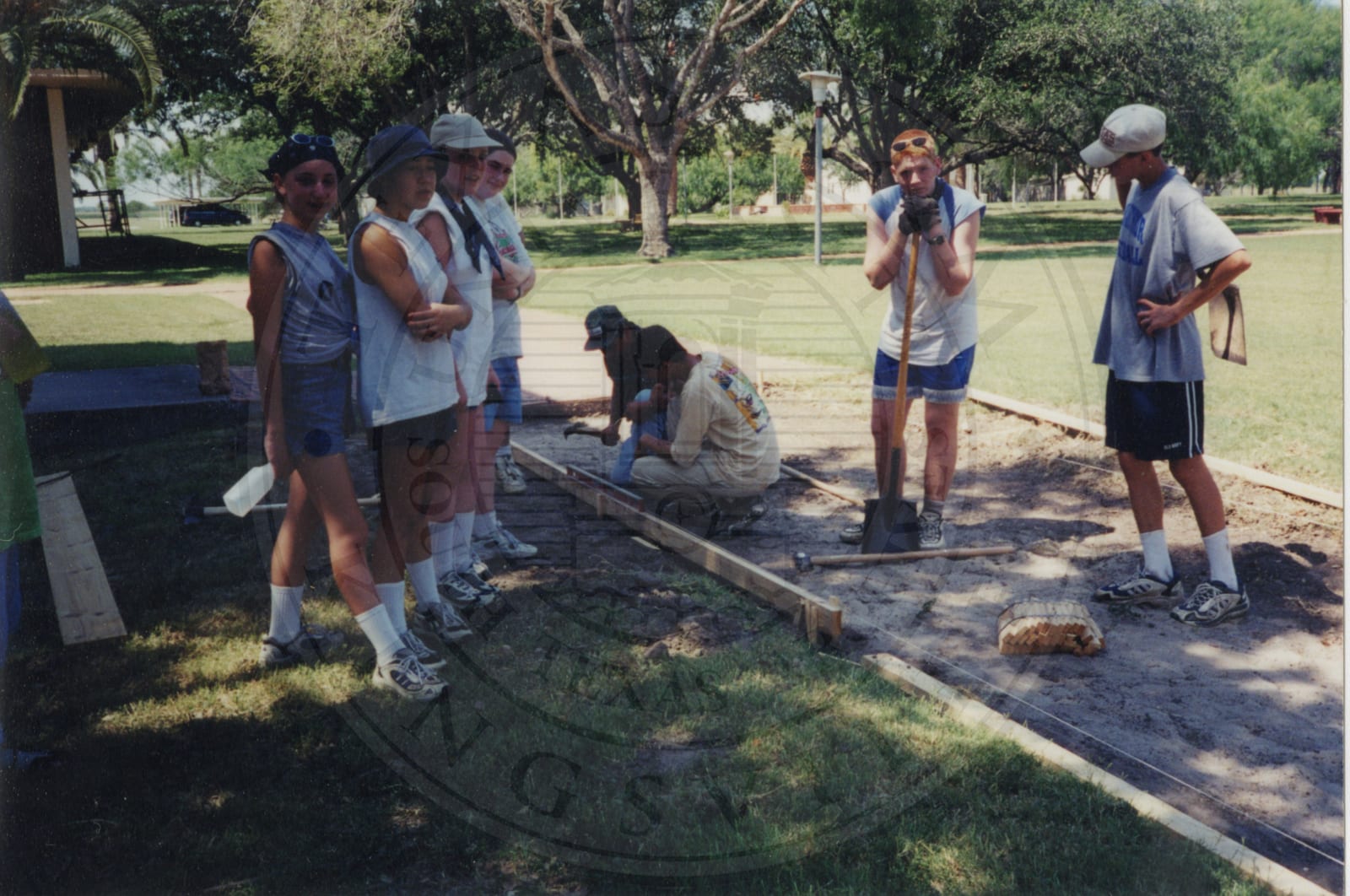 A concrete sidewalk laid by First Presbyterian Church, Garland, Texas, June 12, 1999 — Dr. Matthews among the volunteers.