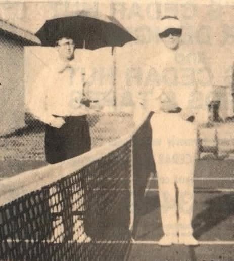 Opening the new tennis courts, which the Class of 1977 started the fund to build: Boyd Chessman holds the umbrella.