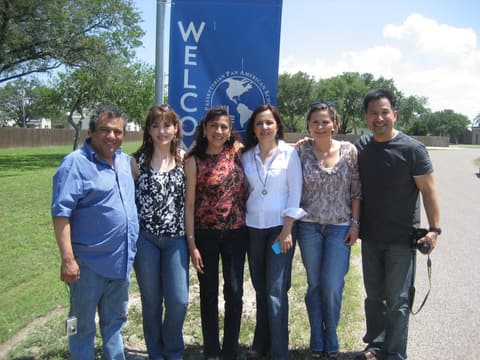 “Our first photo at Pan Am after 30 years”: friends from the early 1980s at the Welcome banner before the Centennial.
