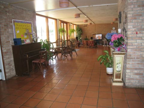 The girls’ dorm lobby with its piano and plants, 2012.