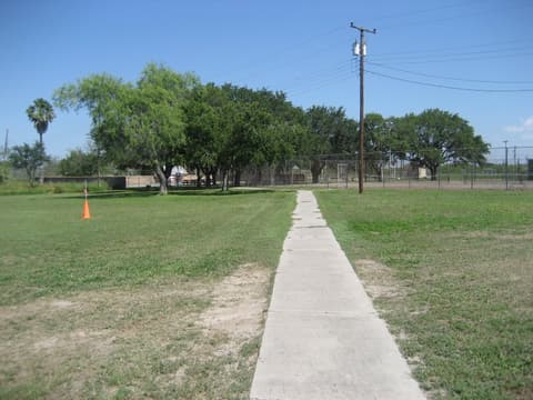 A sidewalk across the lawn toward the tennis courts, 2012.