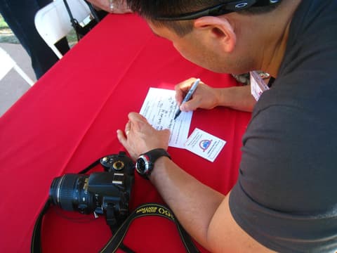 An alumnus fills out his name tag at the Centennial sign-in.