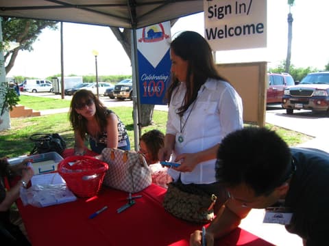 The Centennial sign-in table under the “Celebrating 100 Years” banner.