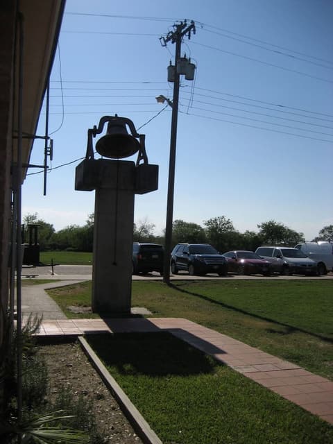 The dining hall bell on its pillar; in the 1950s everything ran by it — rising, breakfast, classes and chapel.