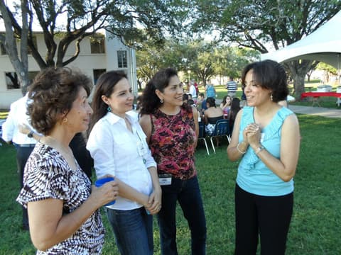 Friends catching up under the tents at the Centennial barbecue, May 2012.