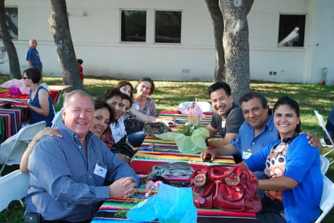 Friends catching up under the tents at the Centennial barbecue, May 2012.