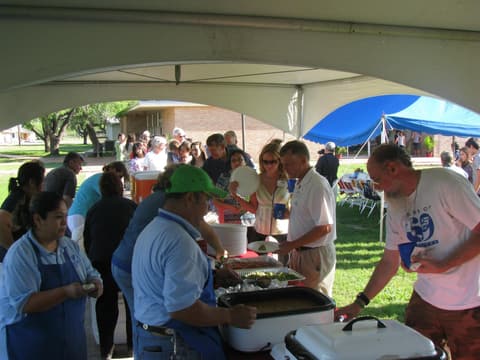 Friends catching up under the tents at the Centennial barbecue, May 2012.