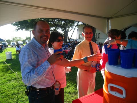 Friends catching up under the tents at the Centennial barbecue, May 2012.