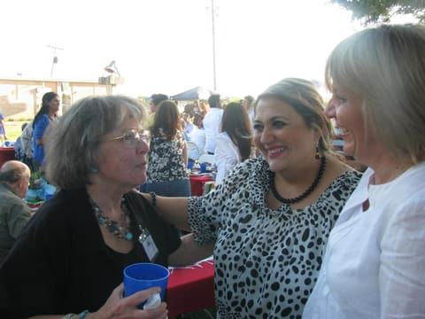 Friends catching up under the tents at the Centennial barbecue, May 2012.