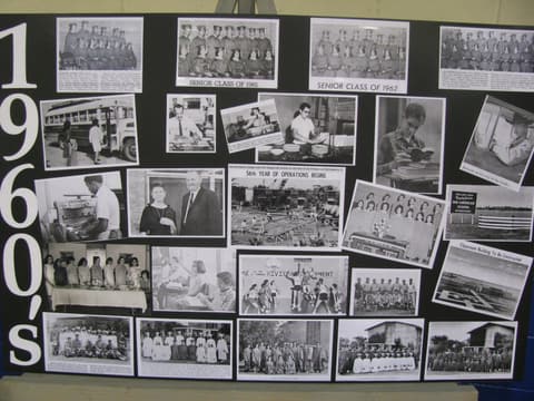 The 1960s history board at the Centennial, covered with photos of senior classes and campus life.