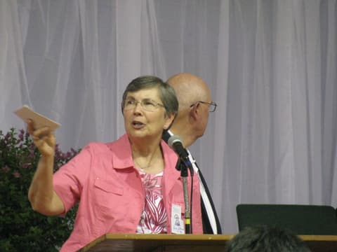 A speaker at the Centennial program in the gym.