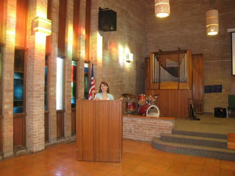 An alumna at the chapel lectern, remembering her chapel talks, 2012.