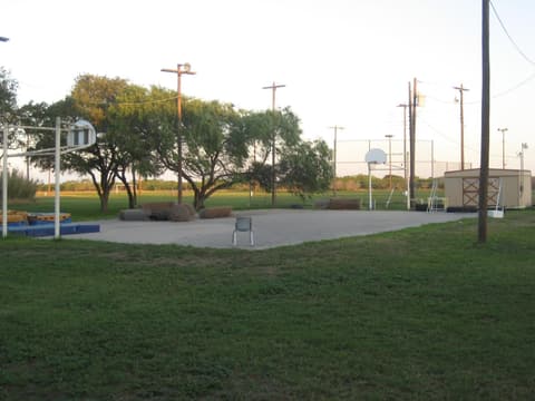 The outdoor basketball court, where alumni remember their first dunks, 2012.