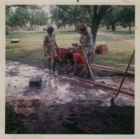 Students laying the campus brick walkways in the early 1970s; commenters name Hector Santana, Izumi Lanier and Ruben Garcia.