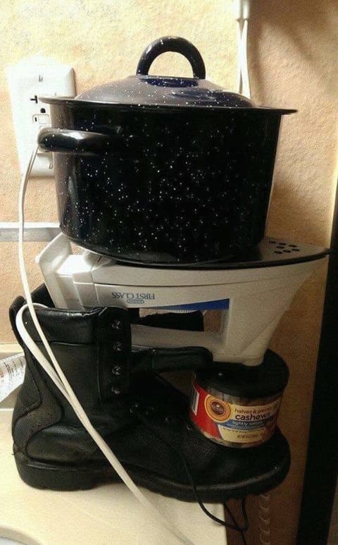 A dorm-room “stove”: a pot balanced on an upturned iron, propped on a boot — how students cooked instant noodles.