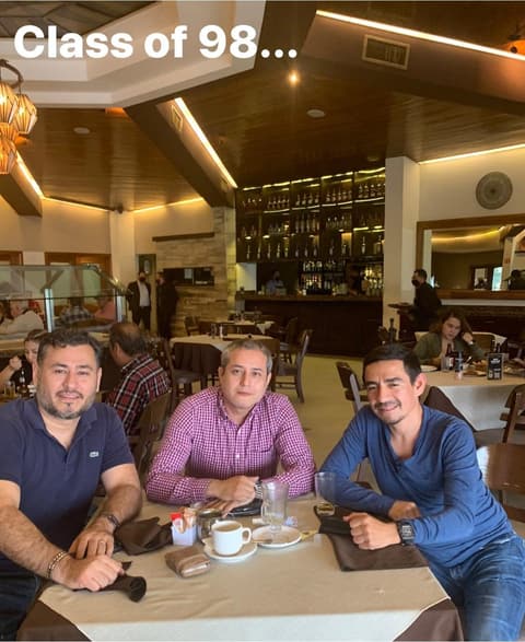 Members of the Class of 1998 catching up over coffee.