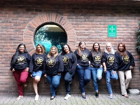 Classmates in matching “JP forever” sweatshirts at a reunion in Mexico, 37 years after graduating.