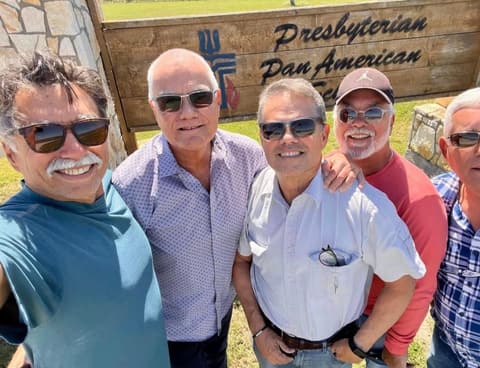 Cuban classmates from the classes of 1971–73 back at the school sign: Dan Cruz-De Paula, Hector Garcia-Ortiz, Miguel Plana, Elpidio Padilla and Manolo Padilla.
