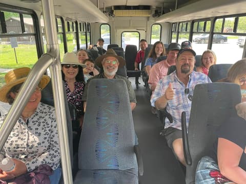 Alumni of the 1970s on a bus outing during a reunion.