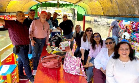 The Class of 1985 on a trajinera boat during its 40th-anniversary reunion.