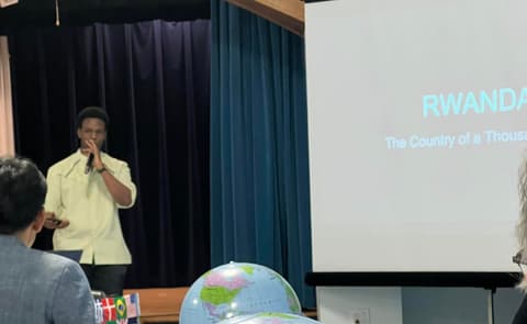 A student presents on Rwanda, “the country of a thousand hills”, at the International Banquet.