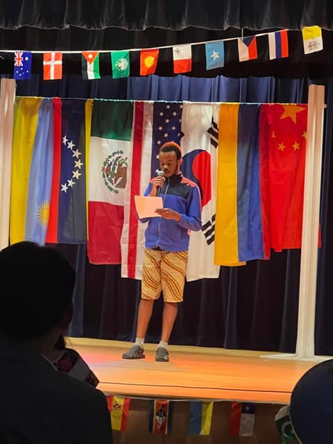 A student reads “Rwanda Elegy” at the International Banquet.