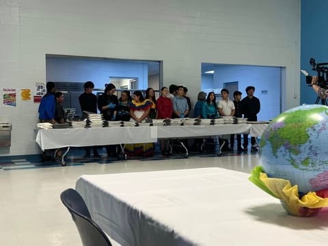 Students serve food from different countries at the International Banquet, March 2024.