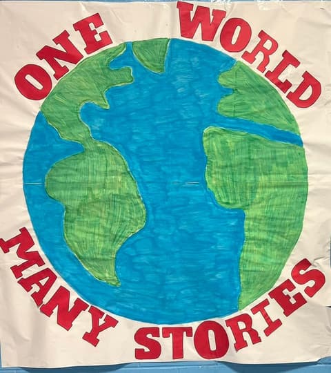 The hand-painted “One World, Many Stories” banner for the International Banquet, March 2024.