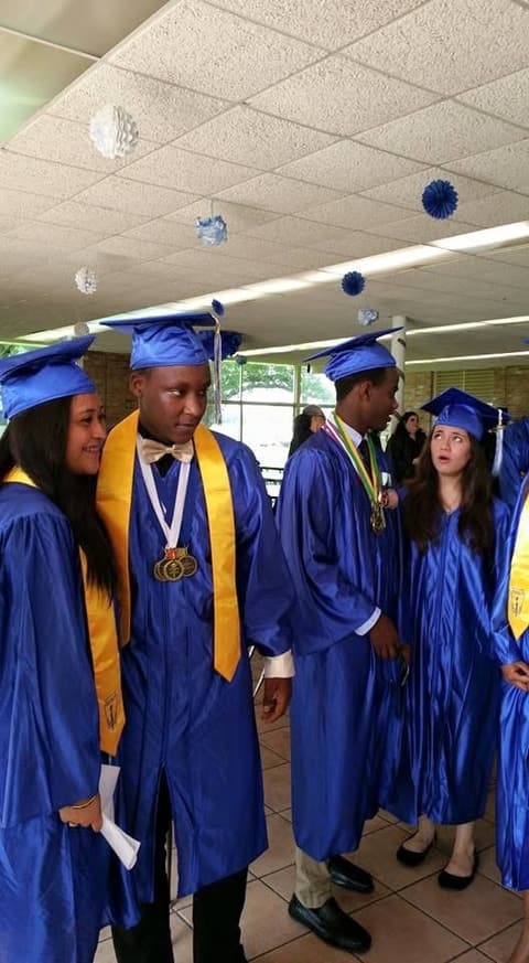 Graduates with their medals in the dining hall.