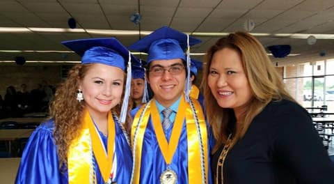 Two honor graduates with a proud alumna in the dining hall.