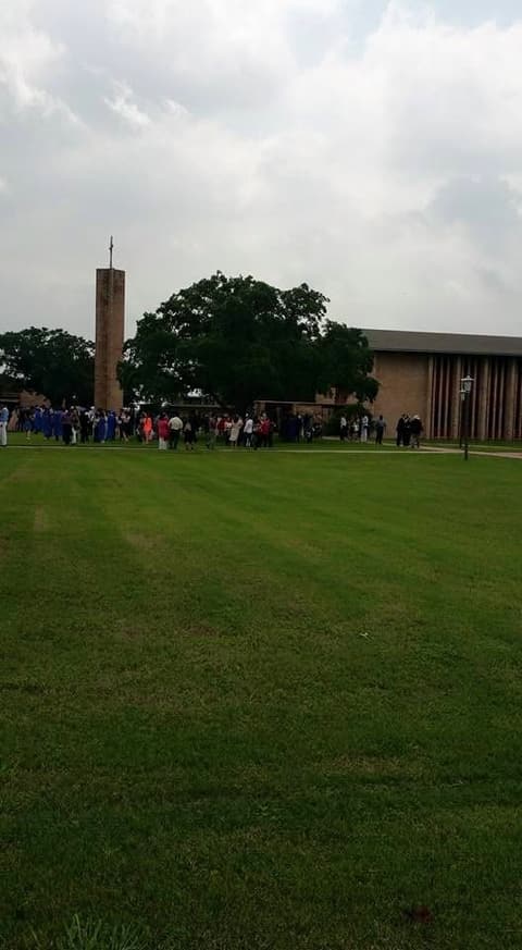 Graduation day on the lawn by the chapel tower.