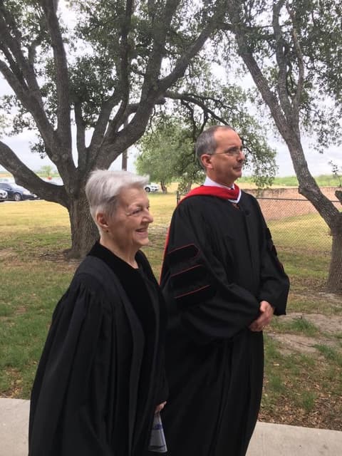 Faculty in academic robes on the way to the graduation ceremony.