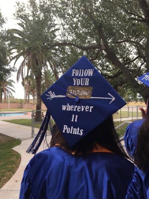 A decorated mortarboard: “Follow your arrow wherever it points”.