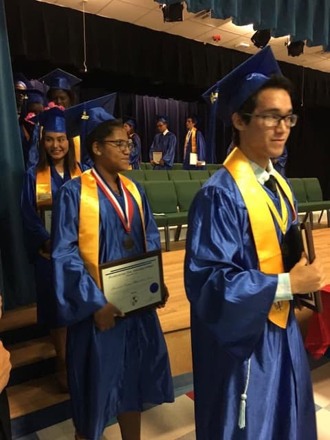 Graduates with their awards leaving the stage.