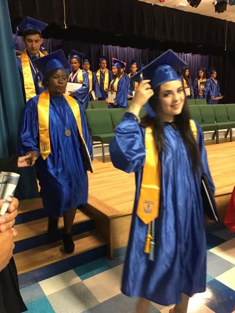 New graduates leaving the stage with their diplomas.