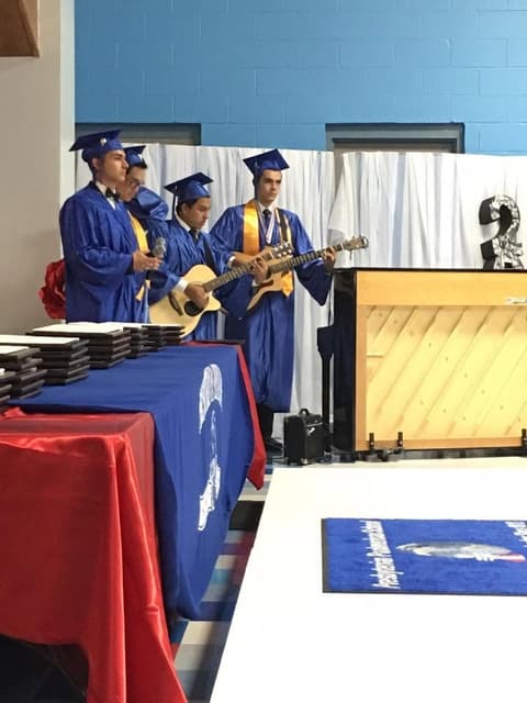 Graduates play guitar during the ceremony.